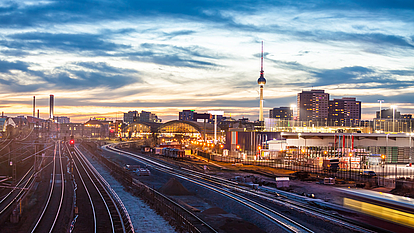 Railway Communication Network Planning Railway tracks and city skyline representing secure communication networks for public transport.
