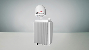 Signal Monitoring Unit with Dome Antenna A compact white signal monitoring unit with a ribbed cooling design and a dome-shaped antenna on top labeled 'LS telcom'. The unit features connection ports beneath the antenna for signal input and output.