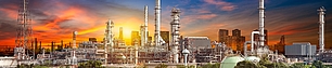 Industrial site at sunset representing spectrum licensing for refineries, ports, and factories